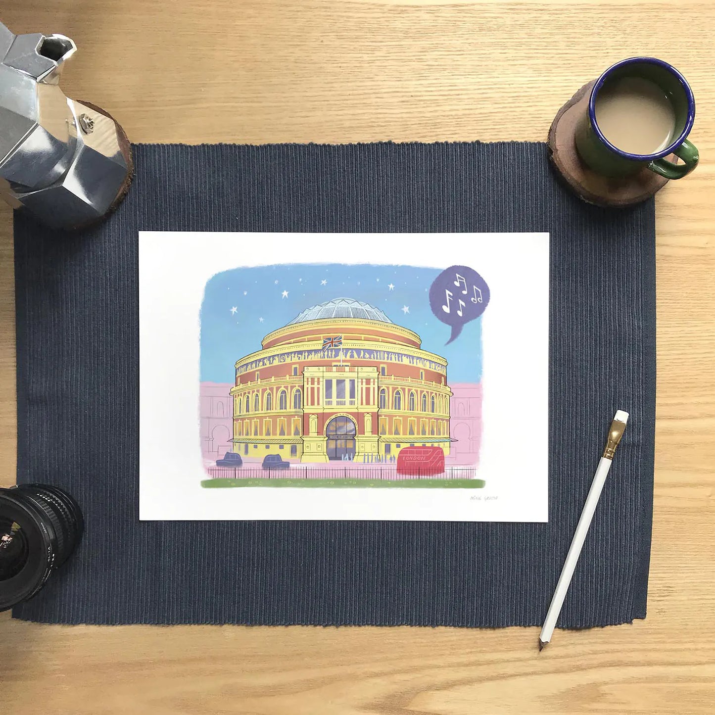 Wall art print of London's Royal Albert Hall on a desk with a pencil and coffee