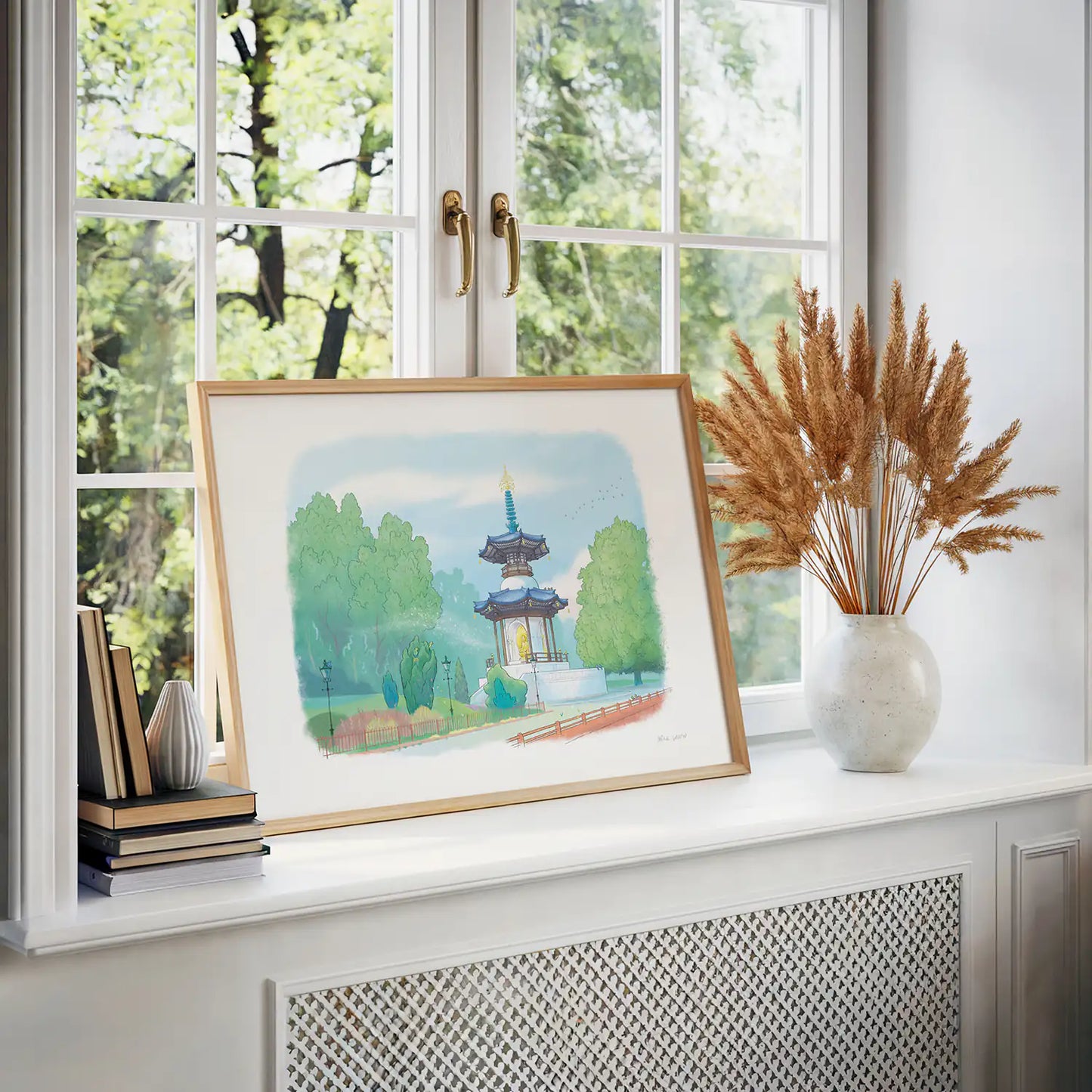 Framed print by a window of a painting of Battersea Parks Peace Pagoda in London by Mike Green Illustration