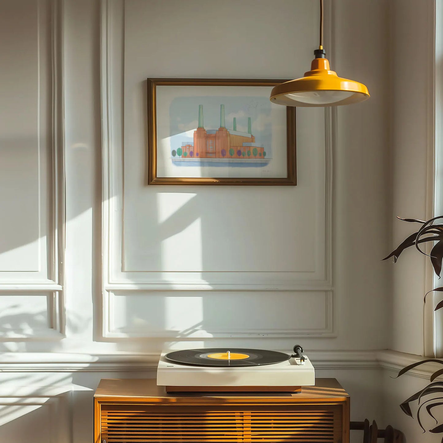An art print of London's Battersea Power Station framed above a record player