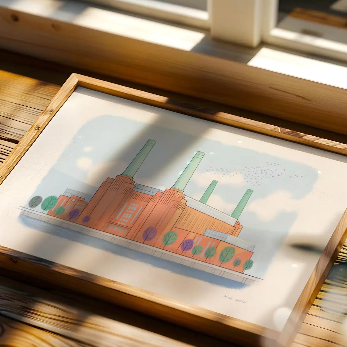 A print of London's Battersea Power Station next to a window in sunlight illustrated by Mike Green