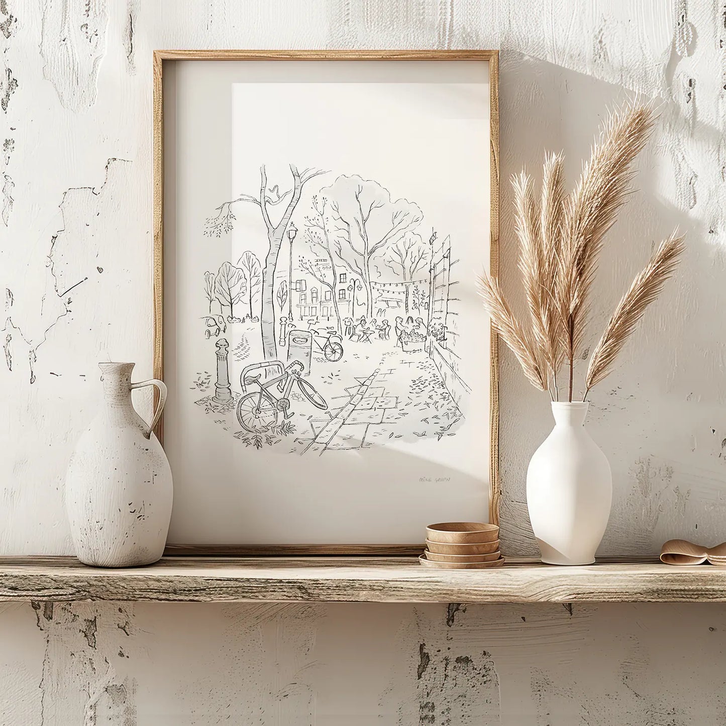 A print of a sketch of Battersea Square in London sitting on a wooden shelf.