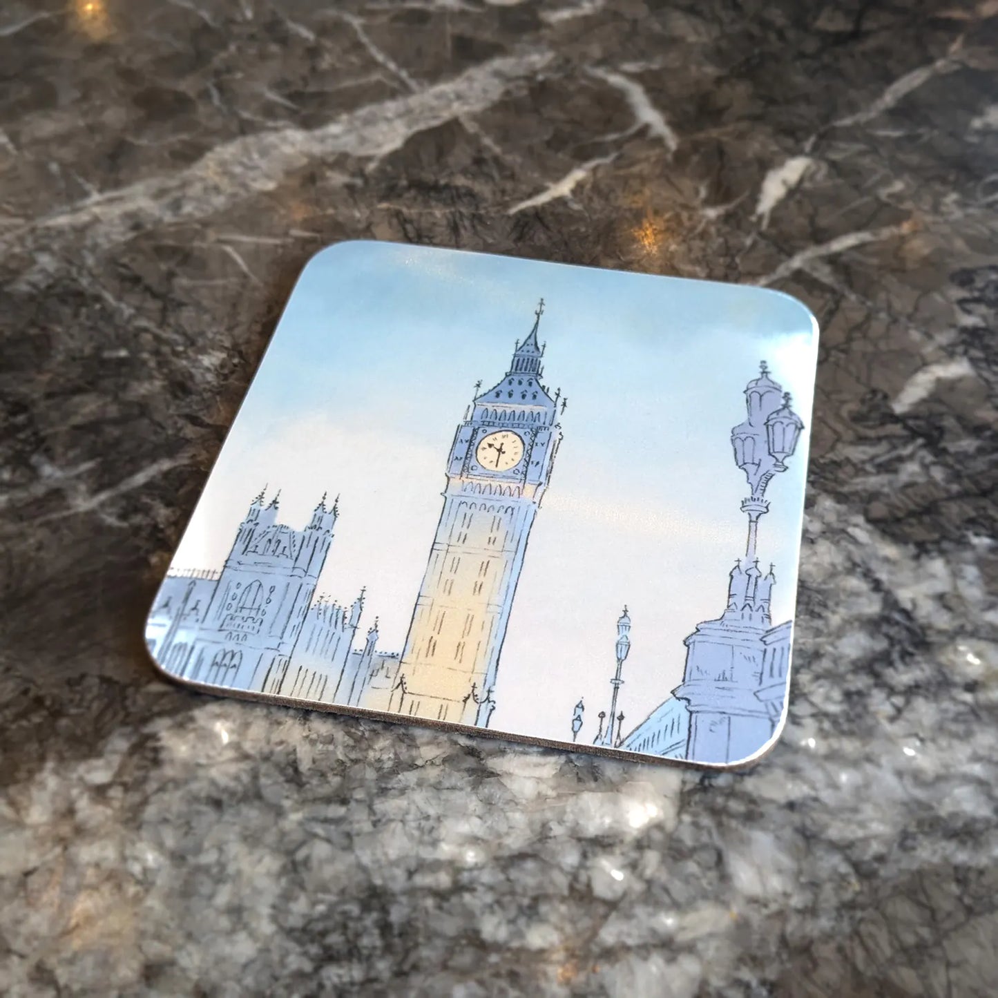 Cork backed square coaster with a painting of London's Big Ben at night on a marble surface