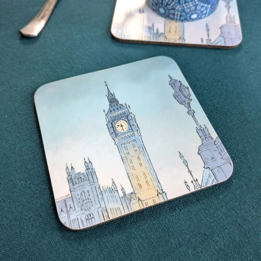Square coaster with a painting of London's Big Ben at night on a blue tablecloth