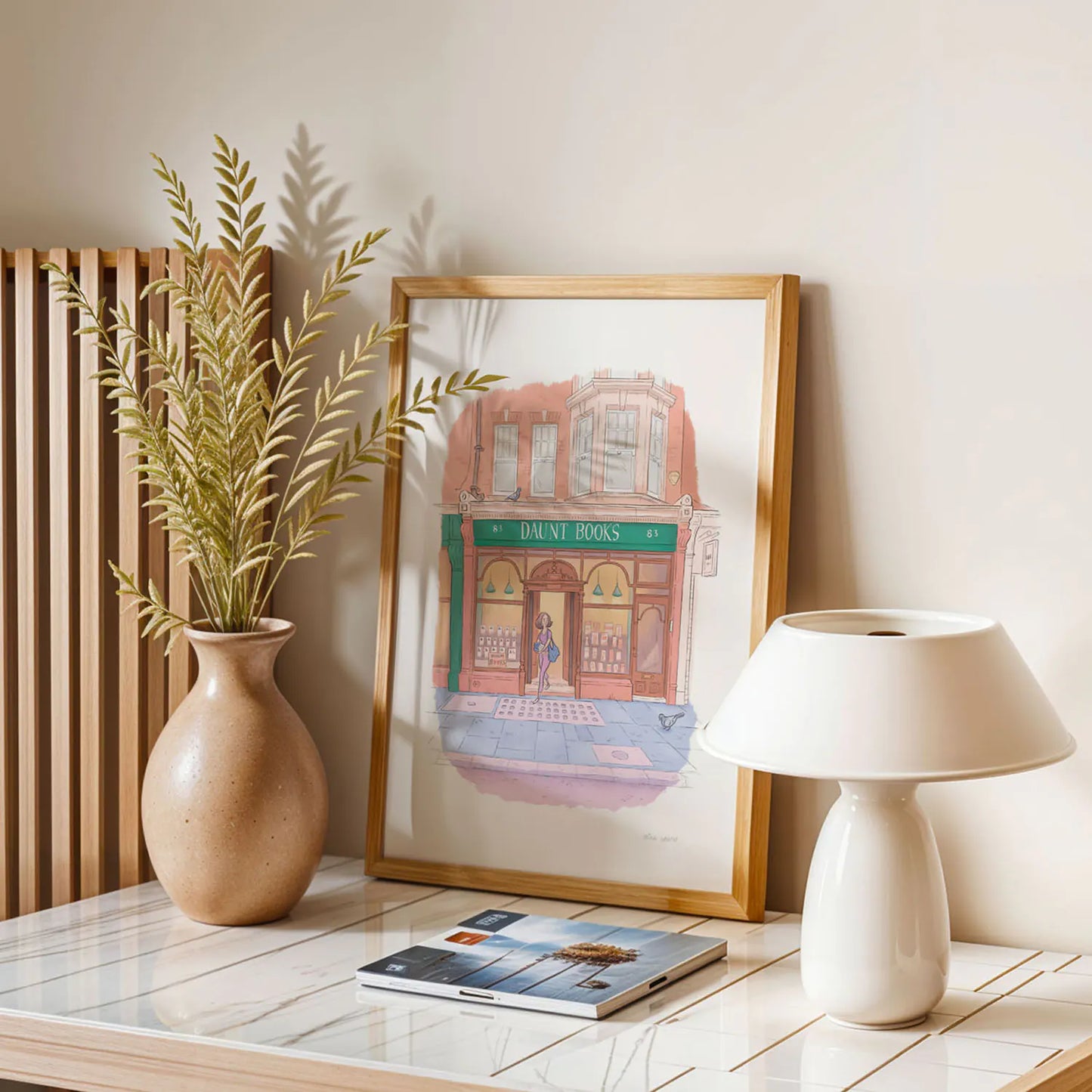 Framed print on a table of a painting of Daunt Books London by Mike Green Illustration
