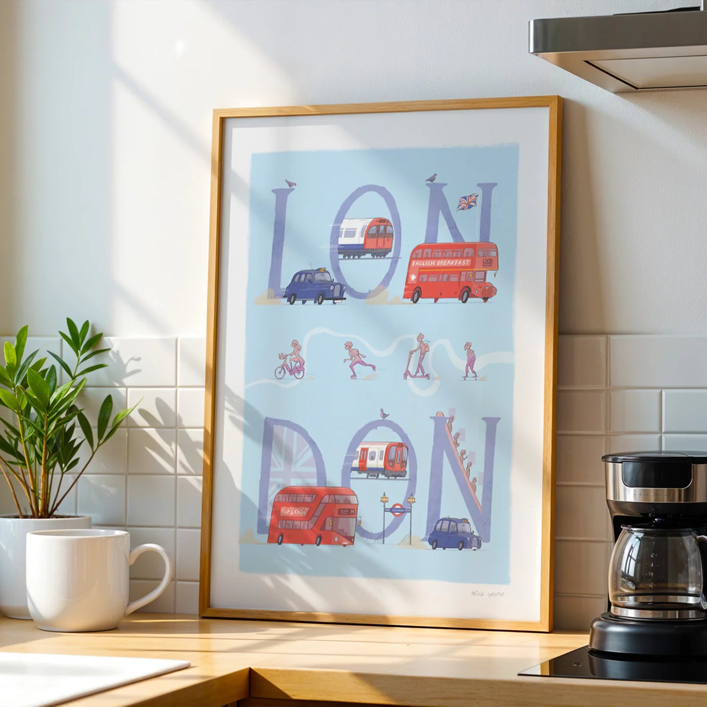 Framed print of a painting of London's transport including busses, taxi's and underground trains.