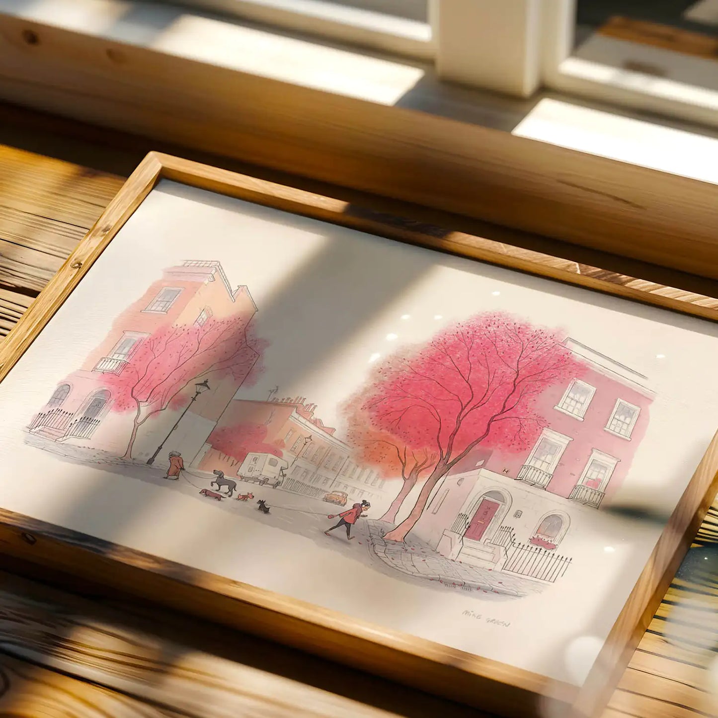 Framed Illustration with 2 dogs catching up on a red tree lined street in London next to window in the sunlight