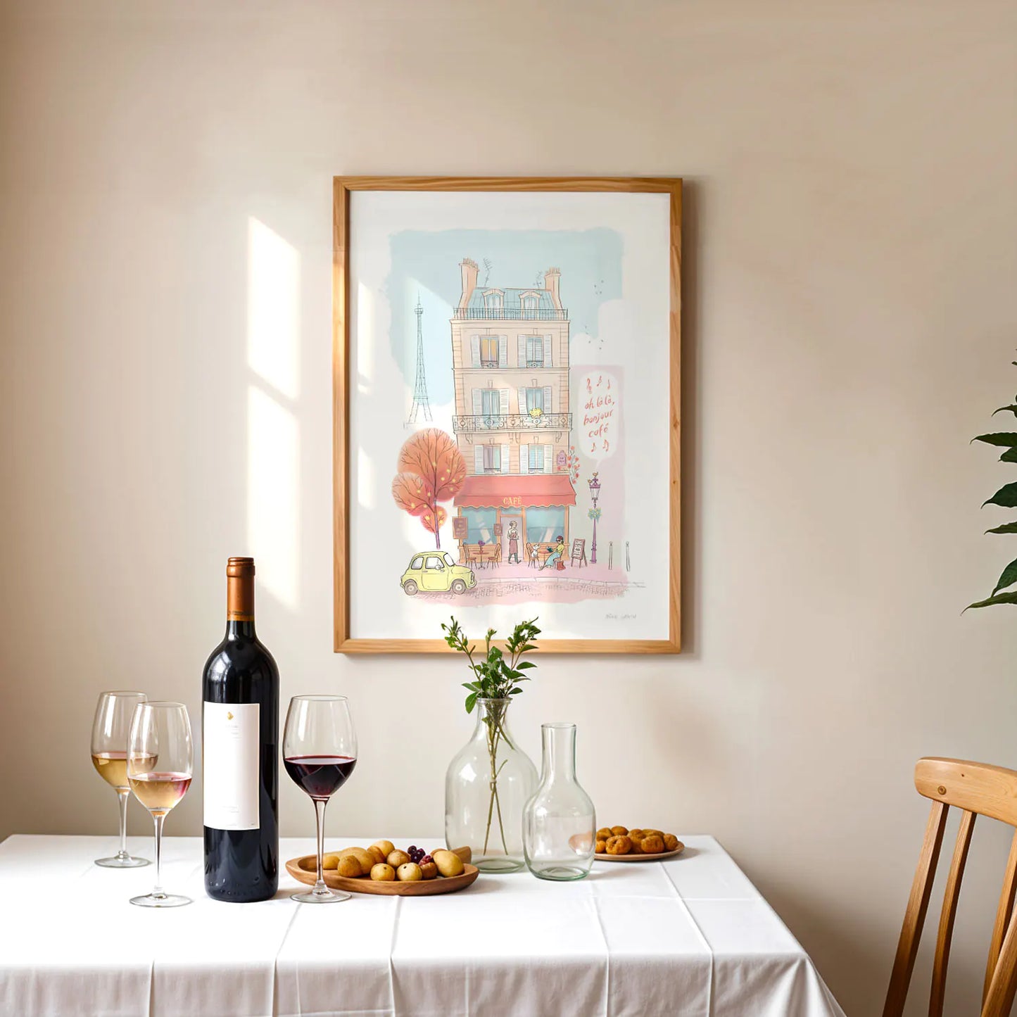 Framed print of an illustration of a typical café in Paris with the Eifel tower in the background with wine on a table