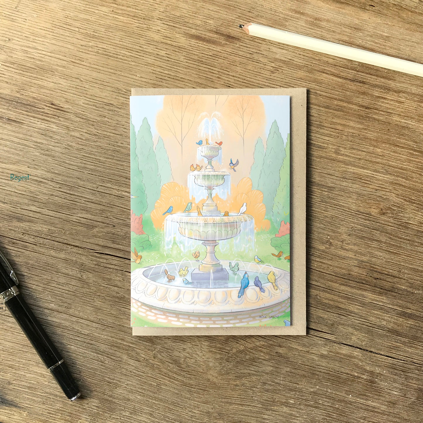 Illustration of colourful birds drinking from a fountain on a greetings card