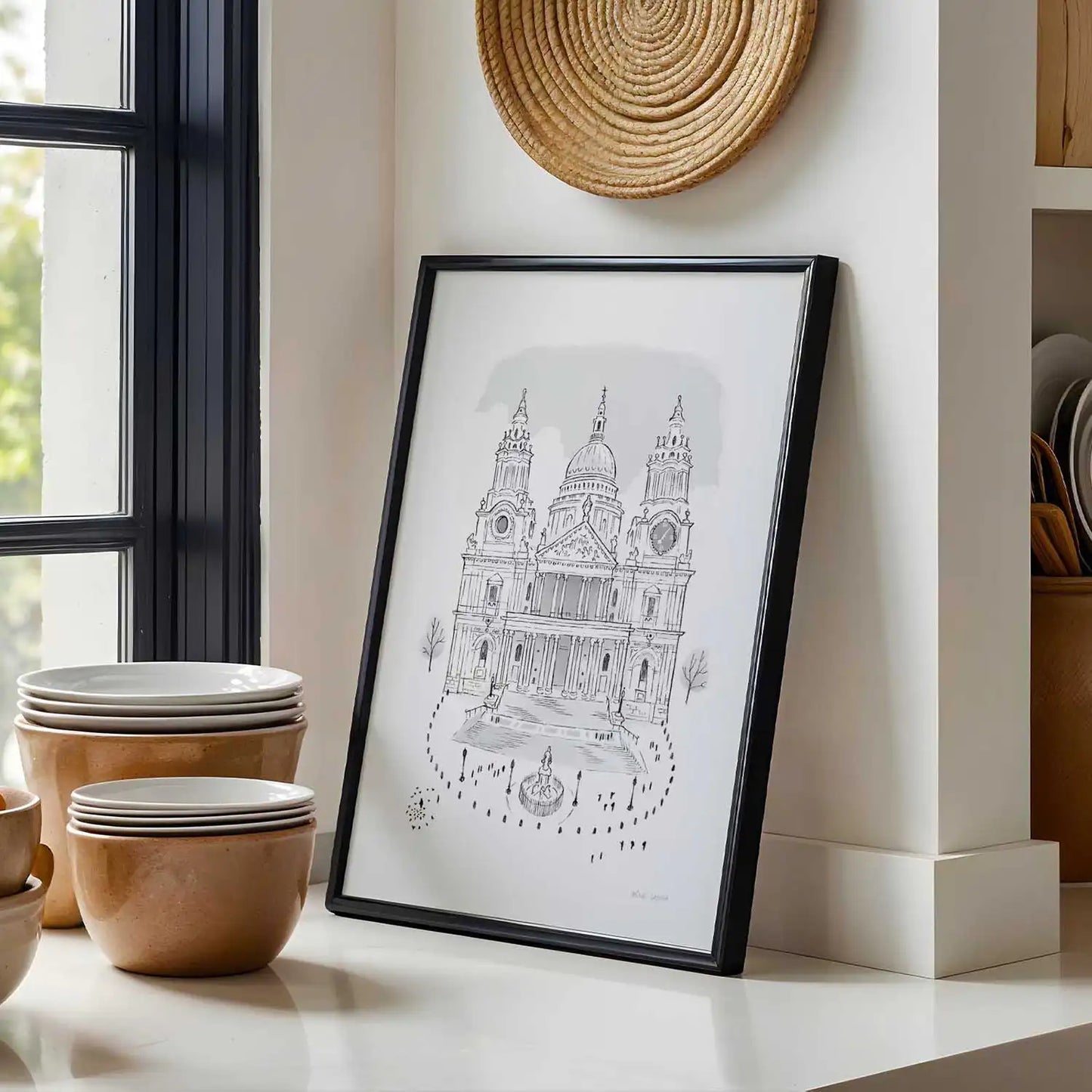 A framed print of London's St Pauls Cathedral in London sketched by Mike Green Illustration in a kitchen