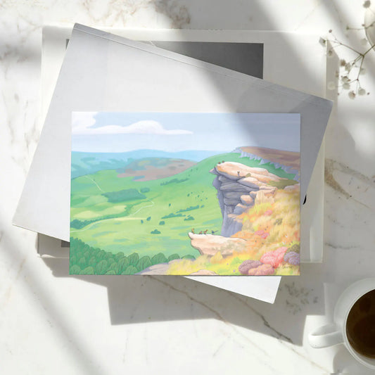 Peak District greetings card on a pile of books with coffee cup
