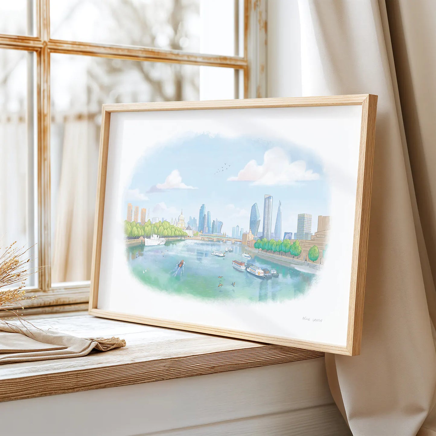 A framed print of a painting of the view from London's Waterloo Bridge towards St Paul's Cathedral next to a window