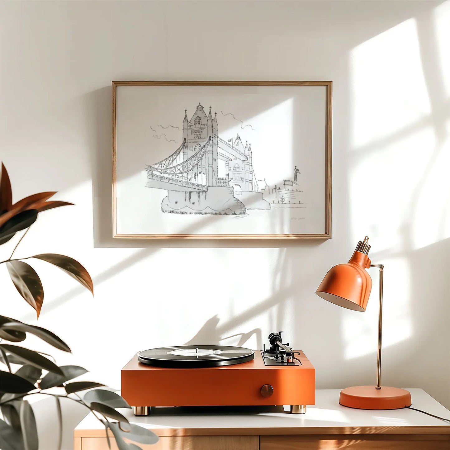 An art print of London's Tower Bridge sketched with a pencil by Mike Green Illustration framed above a record player
