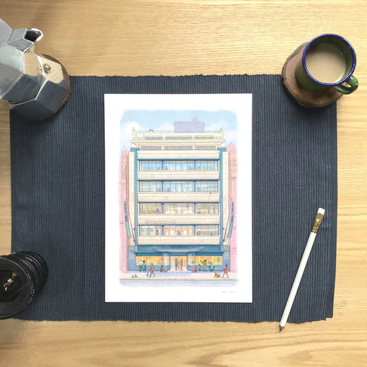 Wall art print of Waterstones Piccadilly bookstore on a mat with a coffee and pencil