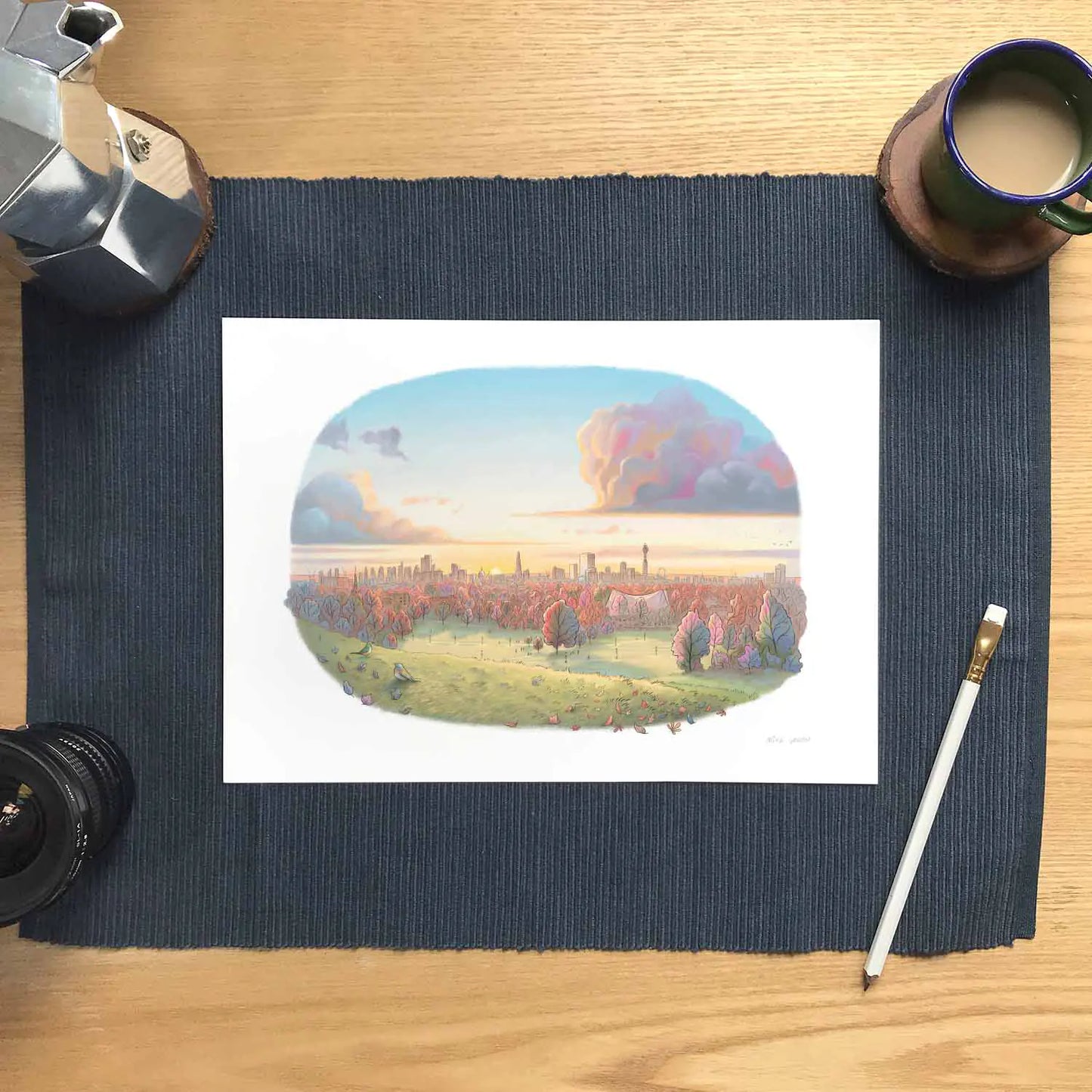 Signed wall art print of Autumn Sunrise on Primrose Hill painting with a pencil and coffee cup