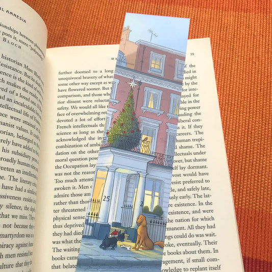 A Dog's Christmas in London bookmark by Mike Green Illustration resting on a book