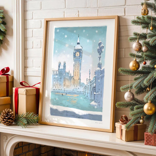 Framed art print of Westminster's big ben in the snow on a shelf with Christmas tree and decorations