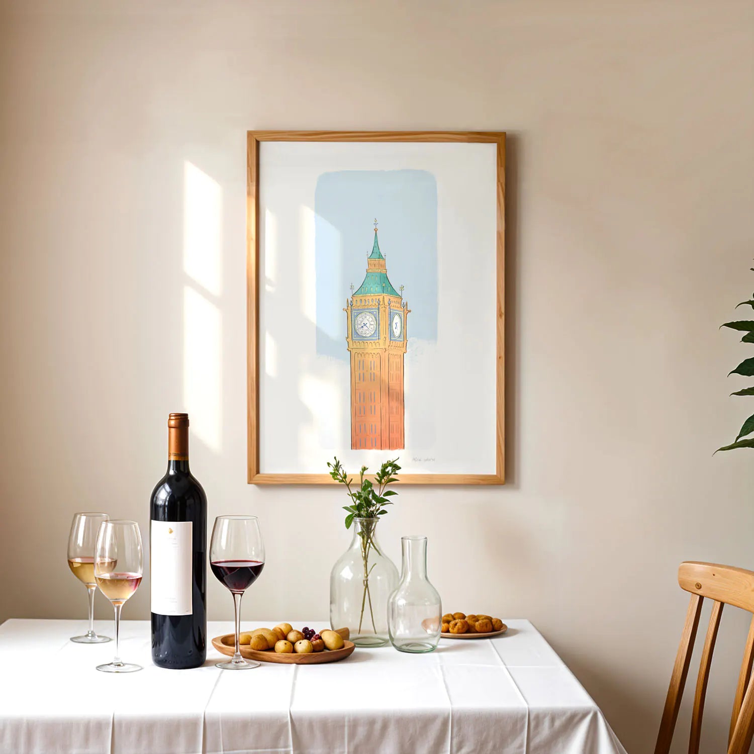 Framed art print of London's Big Ben, the Elizabeth Tower above a table with wine