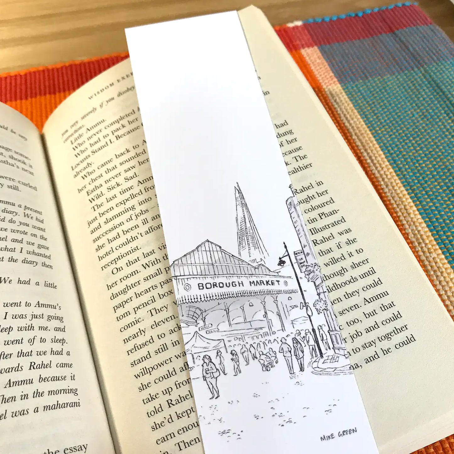 Bookmark with drawing of Borough Market in London resting on a book