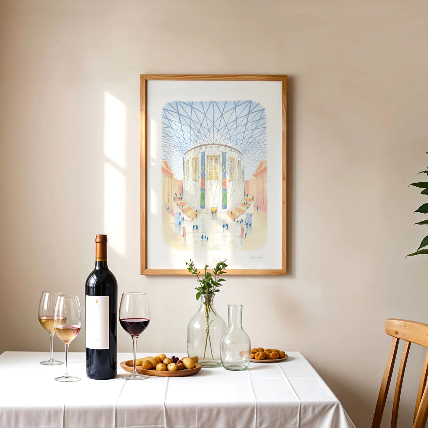 Framed wall art print of the British Museum great court in London with wine and fruit on a table