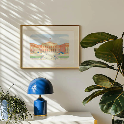 Framed wall art print of The British Museum in London hanging on a wall with a plant and lamp