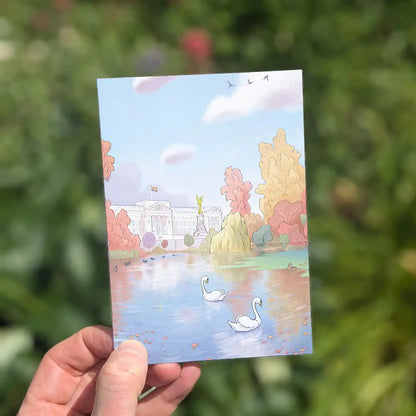 London's Buckingham Palace from St James Park with swans on the lake beautifully illustrated on a greeting card by mike green illustration.