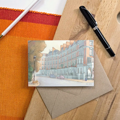 Greetings card with a dog spotting a cat on a west London street in Kensington and Chelsea with a pen and envelope