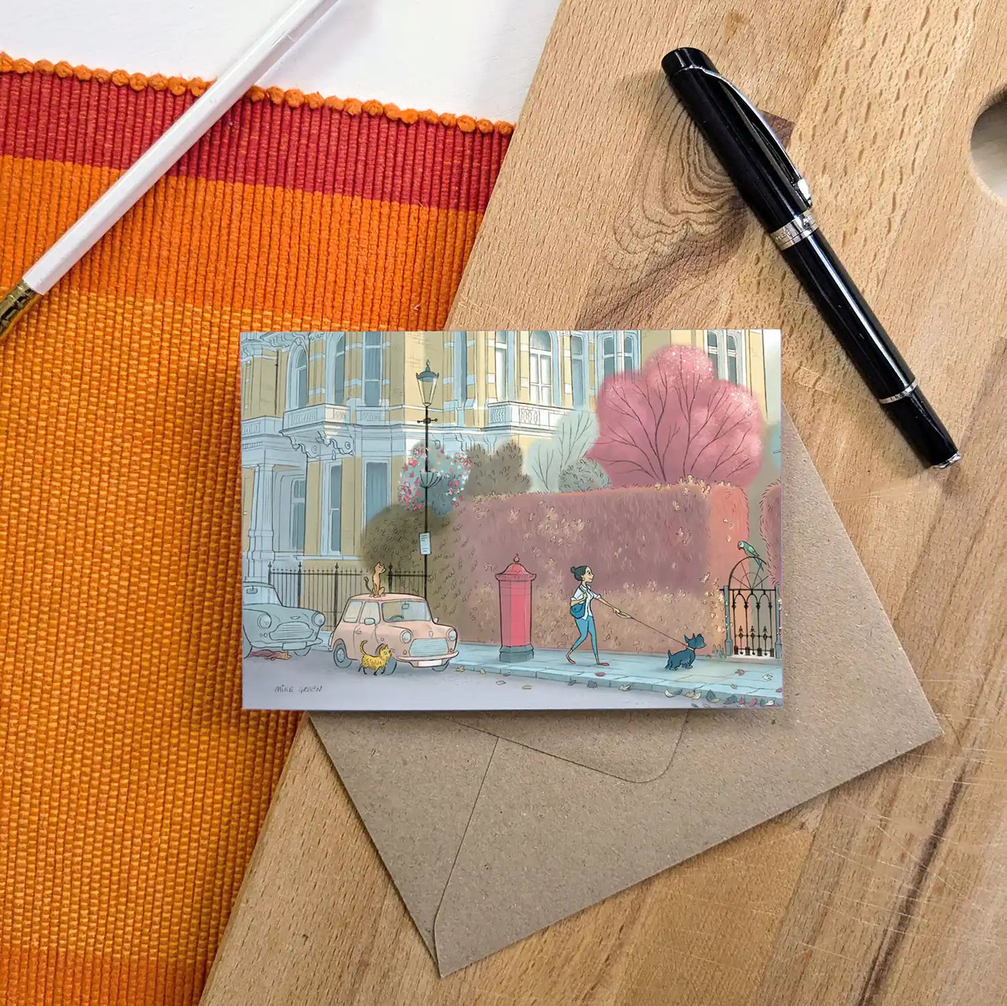 A dog spots a parakeet on a street in London's Kensington in this beautifully illustrated greeting card by mike green illustration.