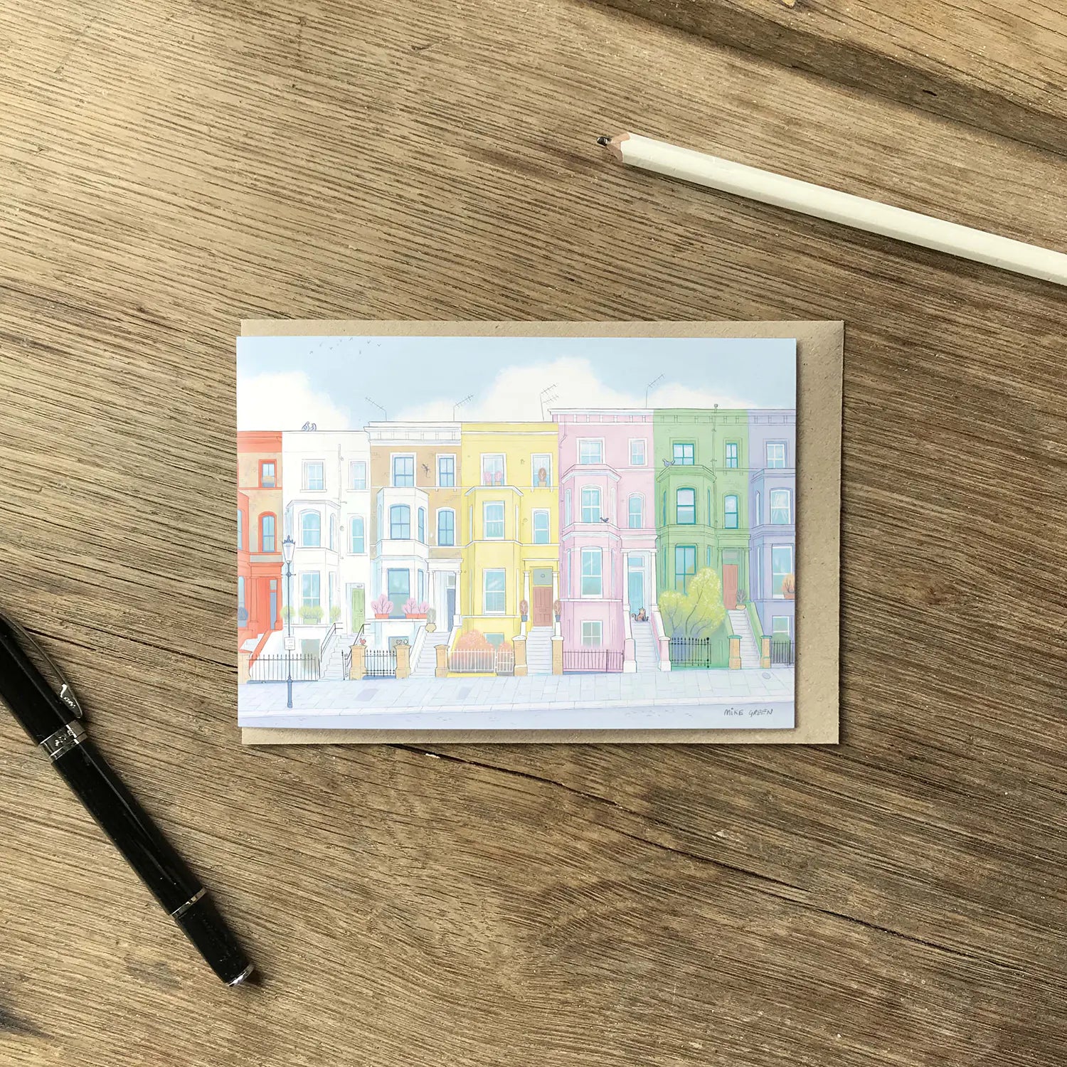 Colourful greetings card with houses from London's Notting Hill with an envelope and pencil
