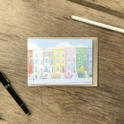 Colourful greetings card with houses from London's Notting Hill with an envelope and pencil