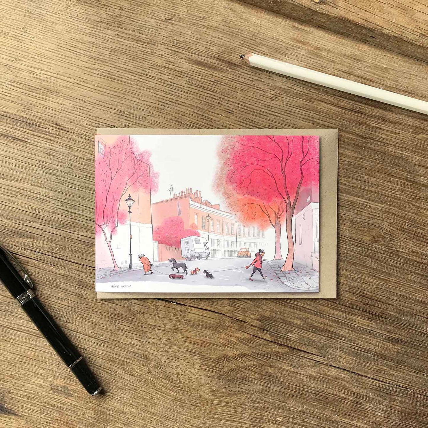 Dogs catch up in the morning on a London street with autumn trees in this beautifully illustrated greeting card by mike green illustration.