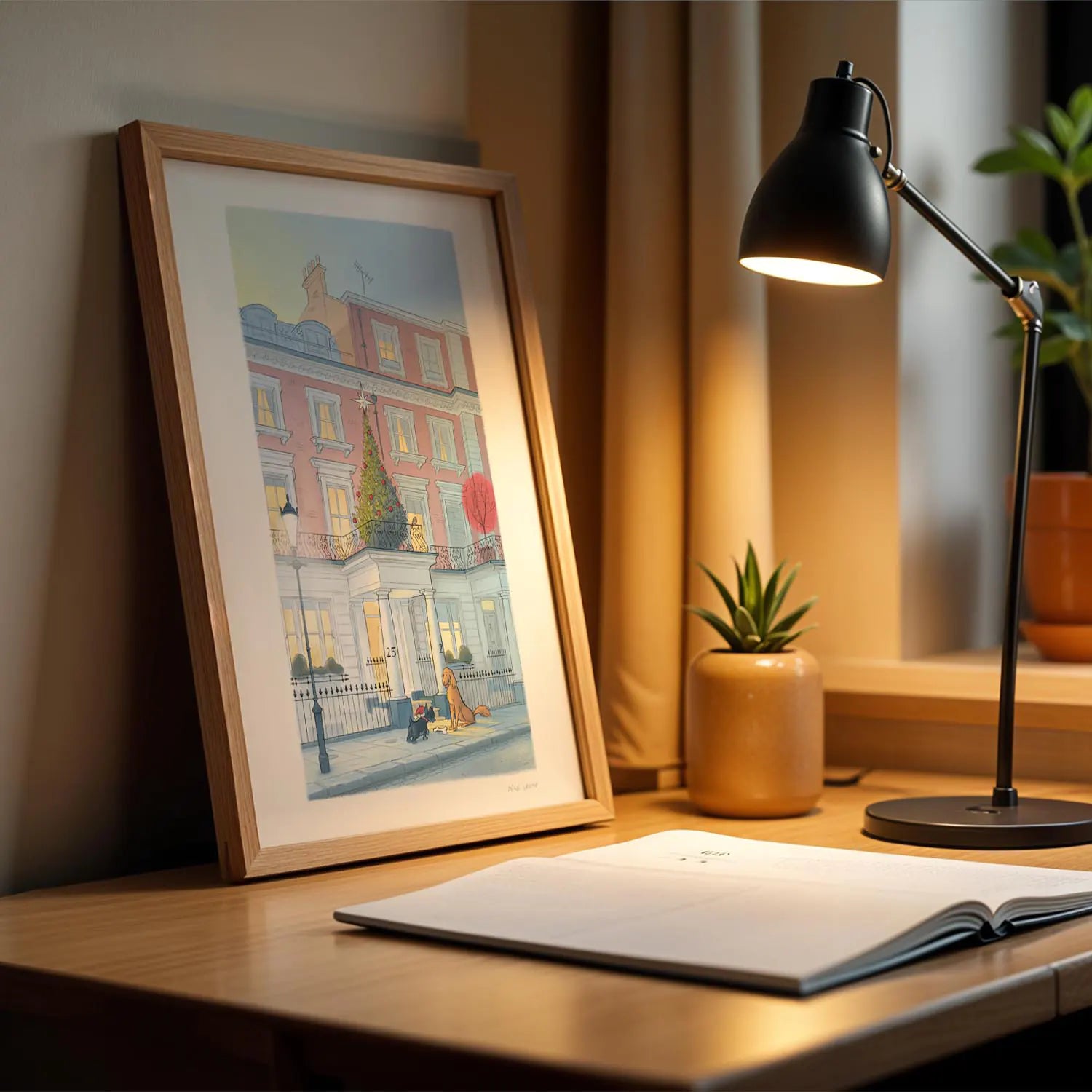 Framed wall art print of a painting of two Dog's at Christmas in London on a desk with a lamp
