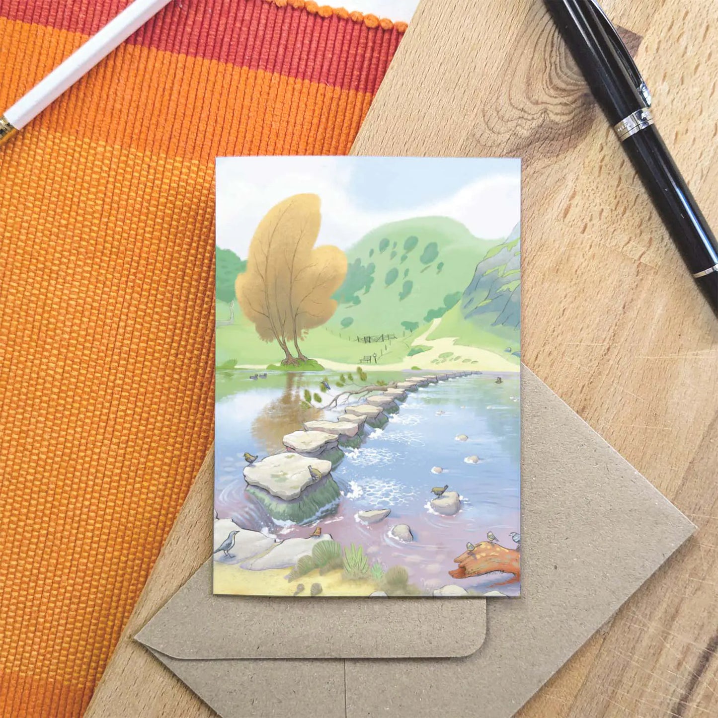Greetings card with a painting of Dovedale Stepping Stones in the Peak District with pen and envelope