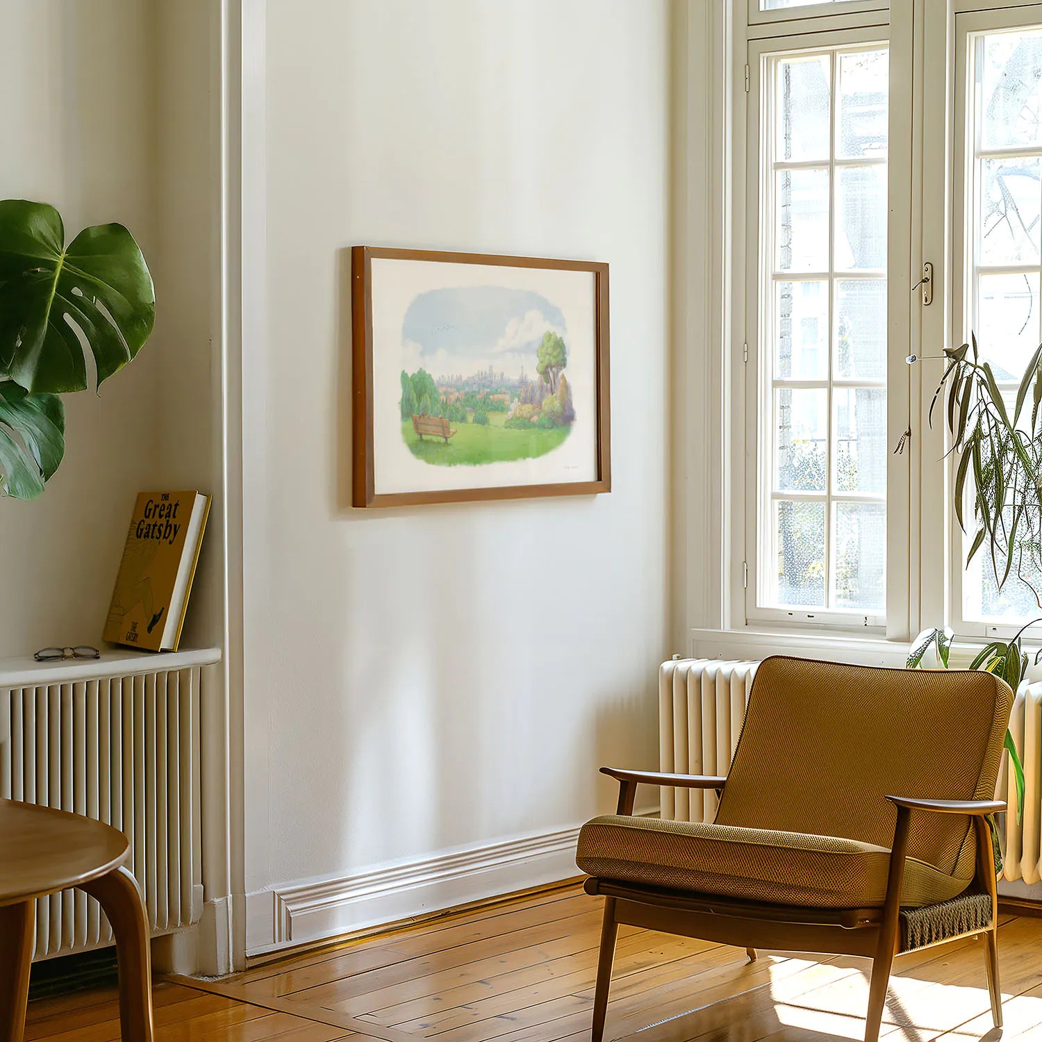 Framed print of painting of the view from Parliament Hill on Hampstead heath in a flat with a chair