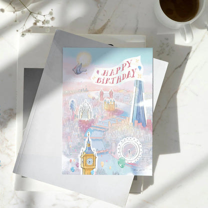 London themed Happy Birthday greetings card featuring a pigeon and Big Ben in a sunny city scape on a pile of books on a marble table