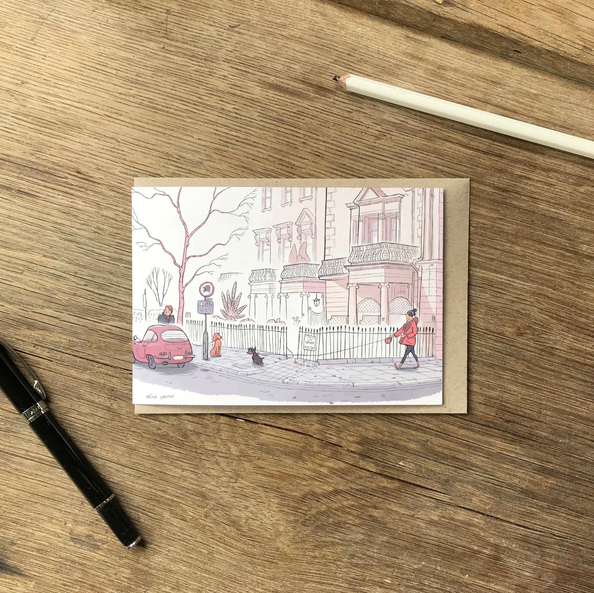 Dog walkers on a street in London's Kensington street beautifully illustrated on a greeting card by mike green illustration.