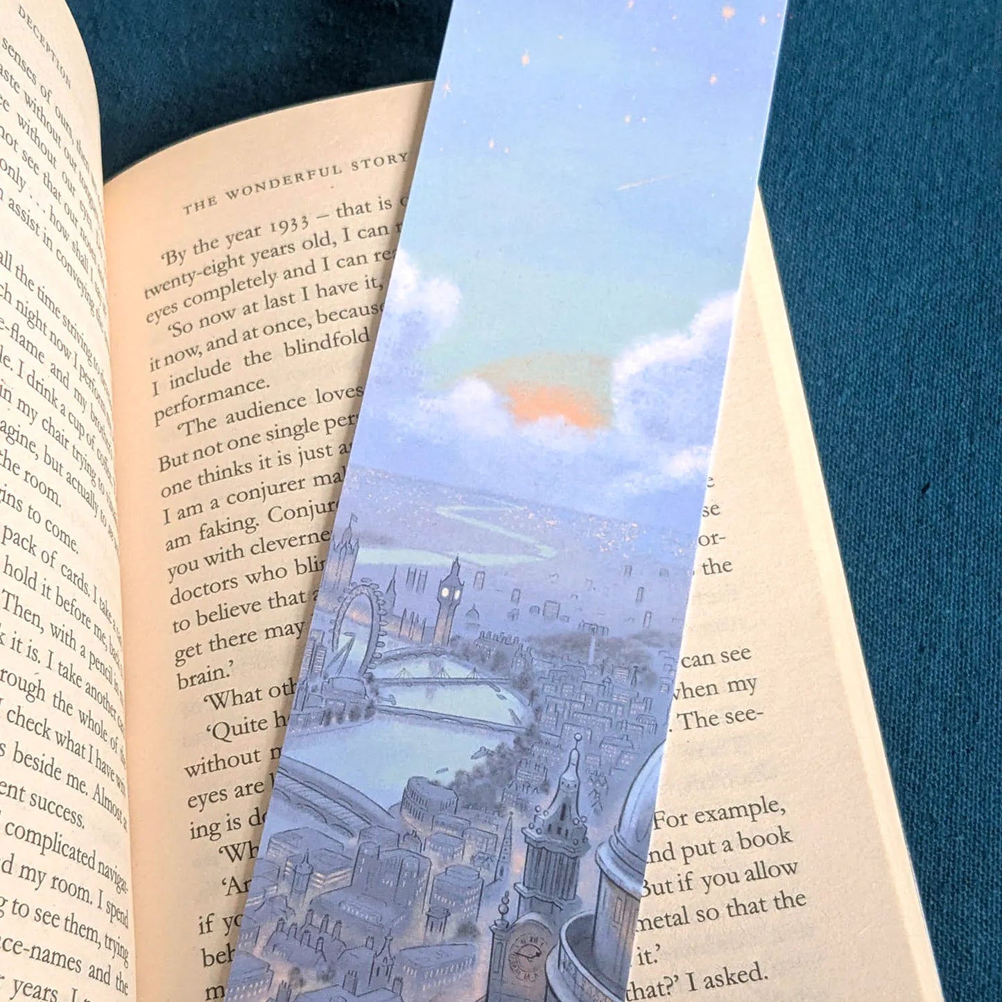 Bookmark of London's skyline at night with St Paul's Cathedral and Big Ben on a book