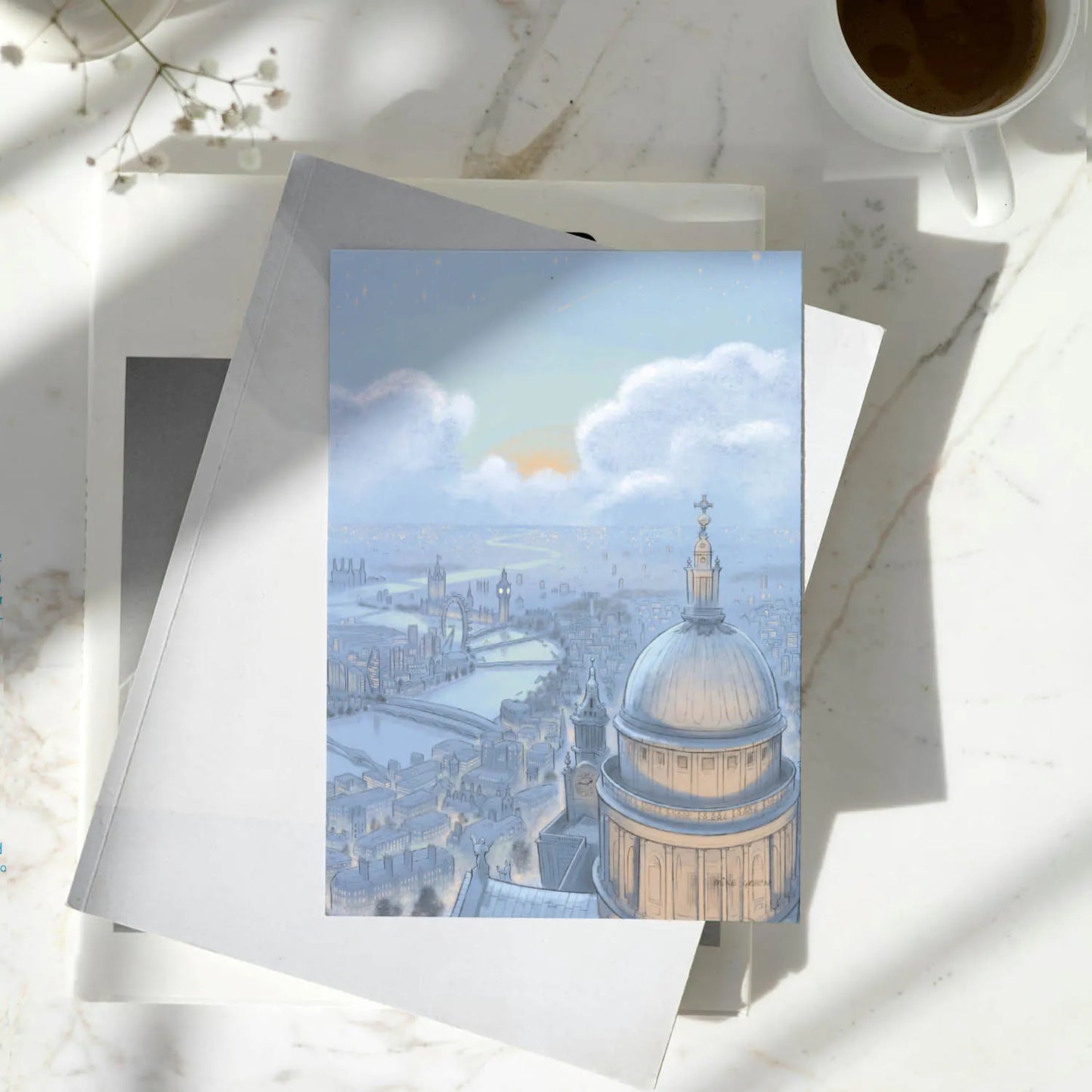 Greetings card with painting of London skyline at night with St Pauls Cathedral and Big Ben on a pile of books