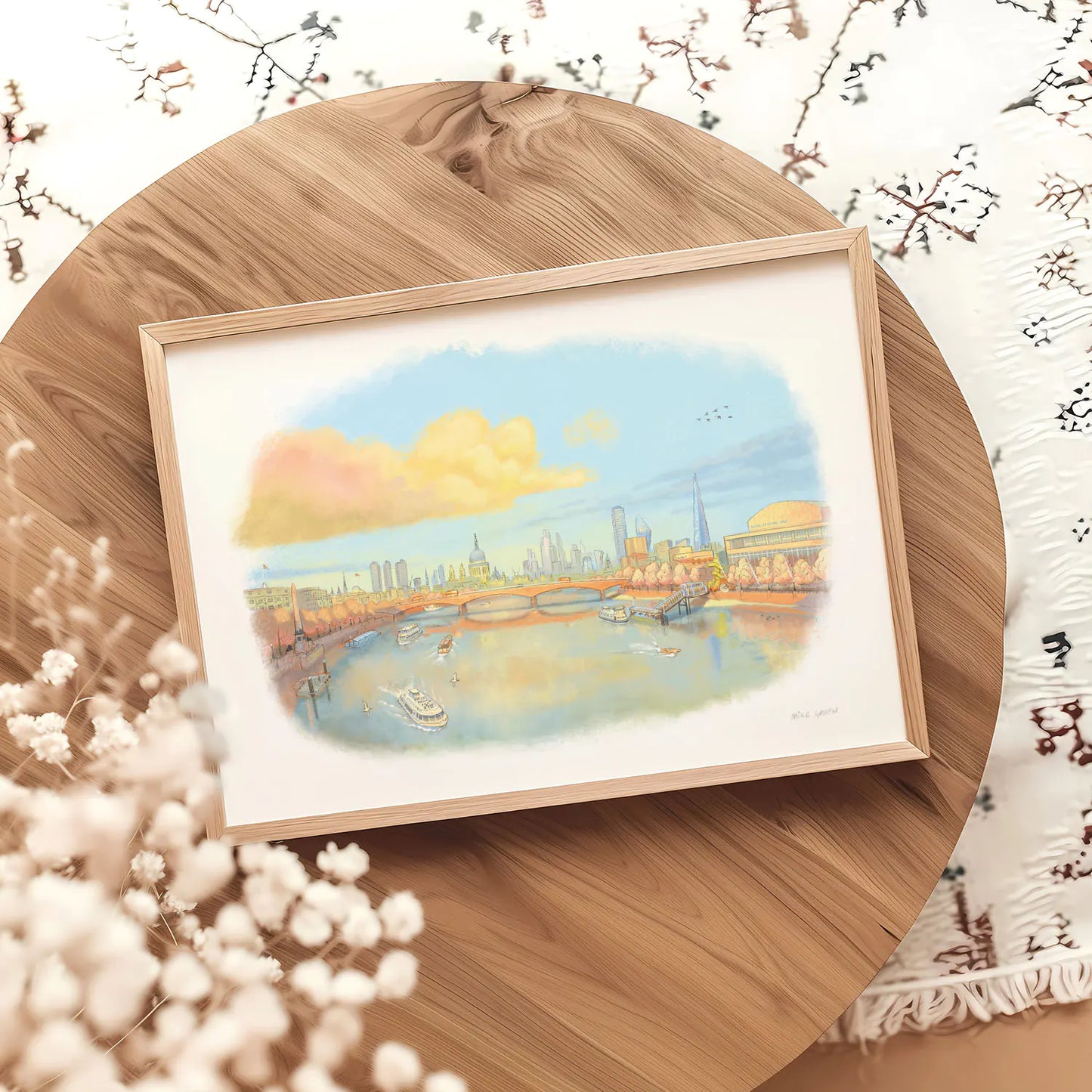 Framed wall art print of London in the evening sunshine with the river Thames and St Pauls Cathedral and the Southbank Centre on a wooden table