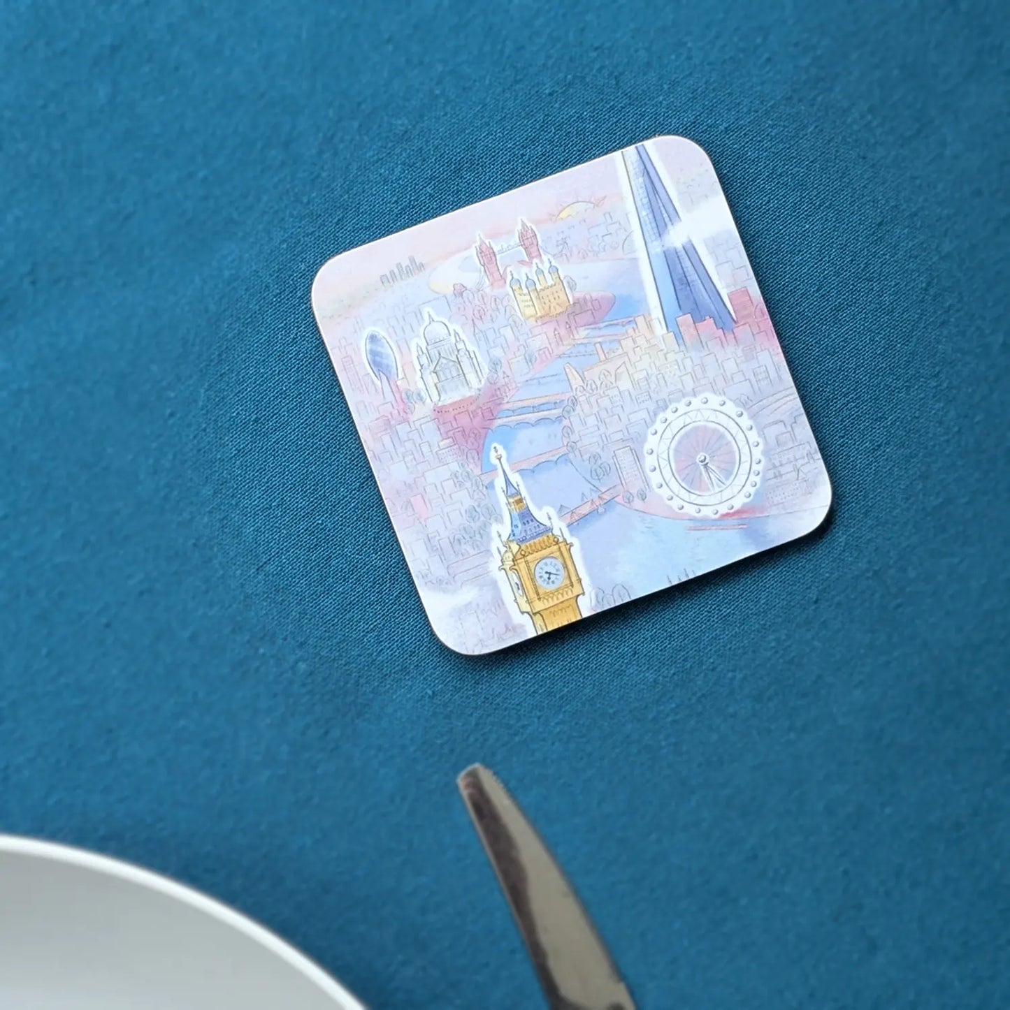Square drinks coaster with a painting of Big Ben, the London Eye, St Paul's and the Shard in pastel colours