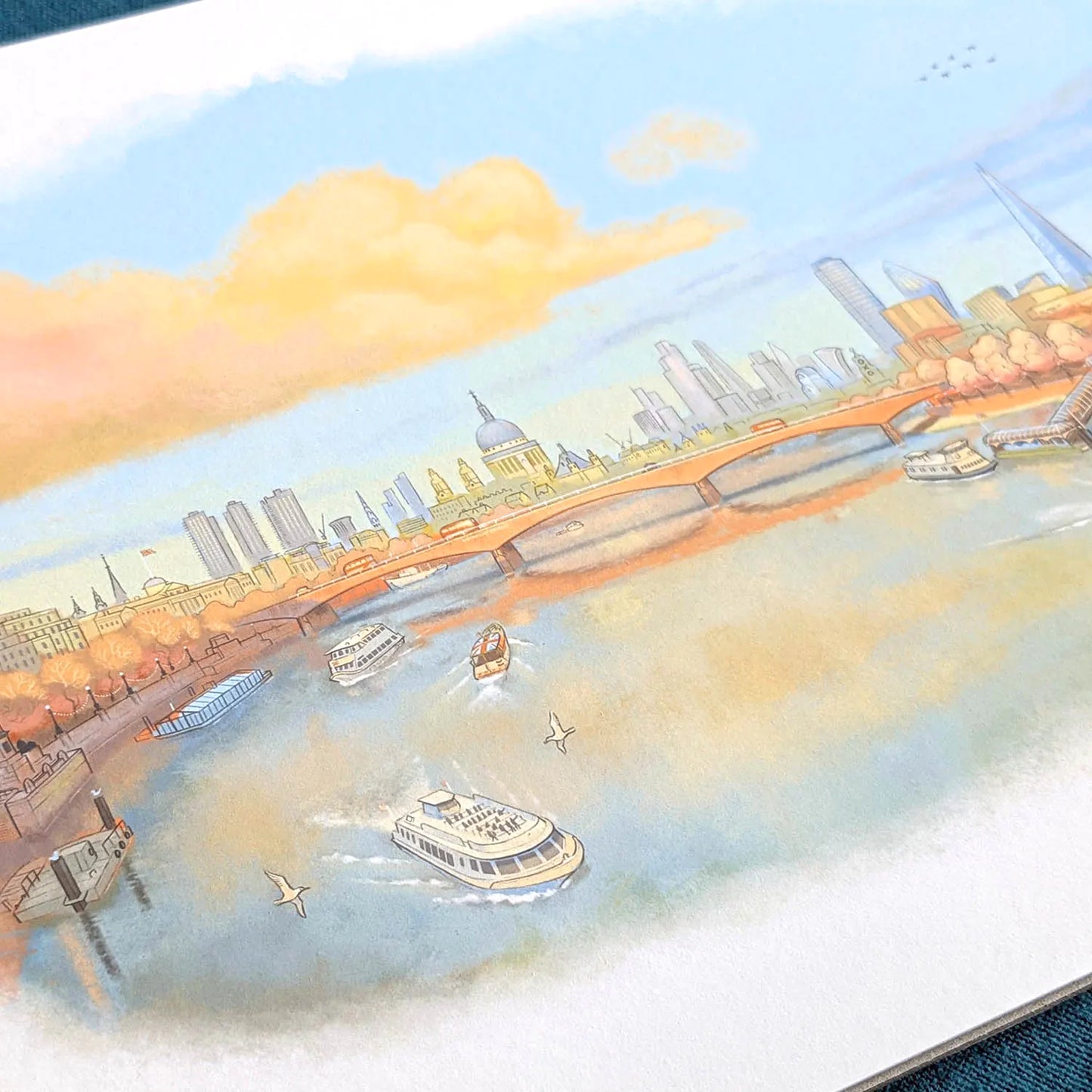 Close up photo of a wall art print of a painting of the Thames in a late evening sunset