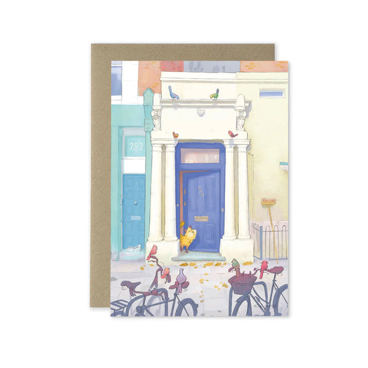 A greetings card with Notting Hill's Blue door from the film with a cat and birds in London