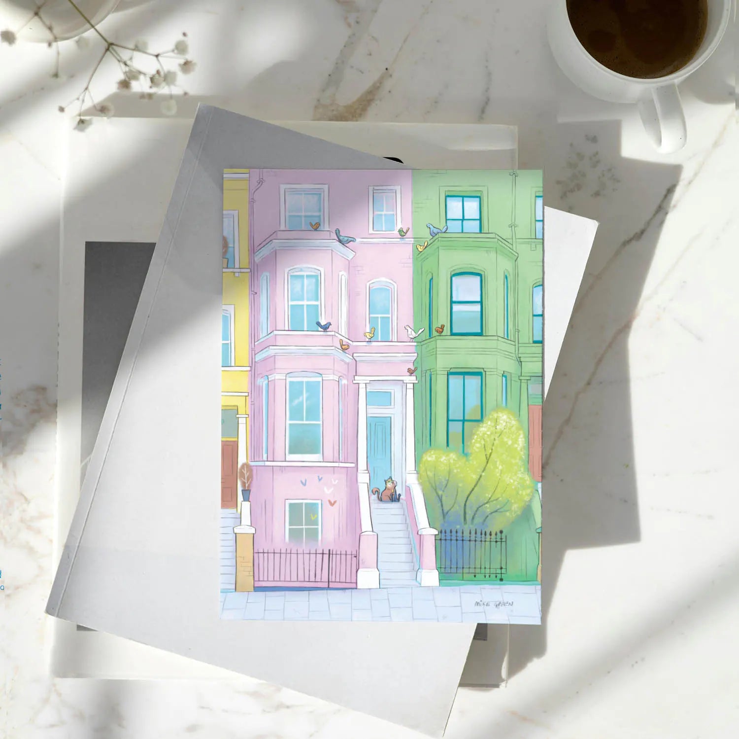 A greetings card with a lazy looking cat admiring some out of reach birds in London's Notting Hill