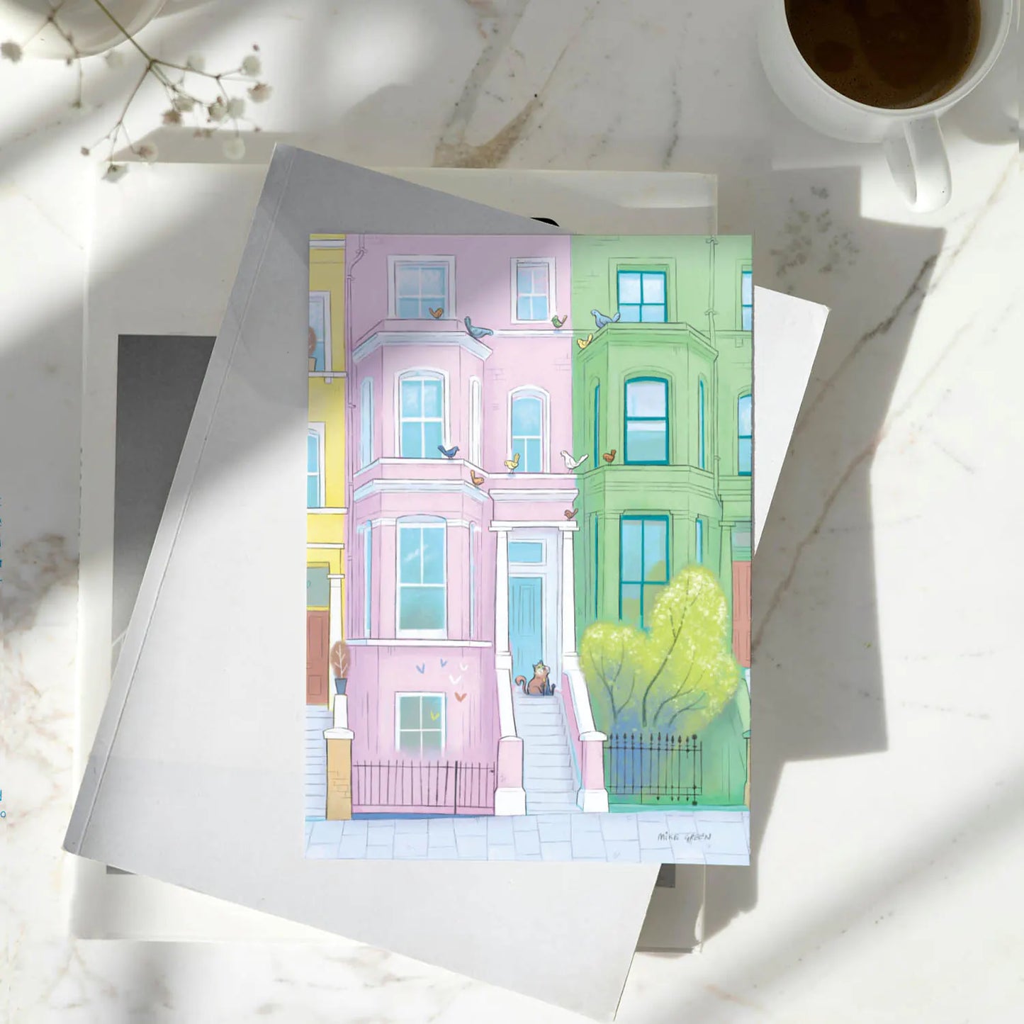 A greetings card with a lazy looking cat admiring some out of reach birds in London's Notting Hill