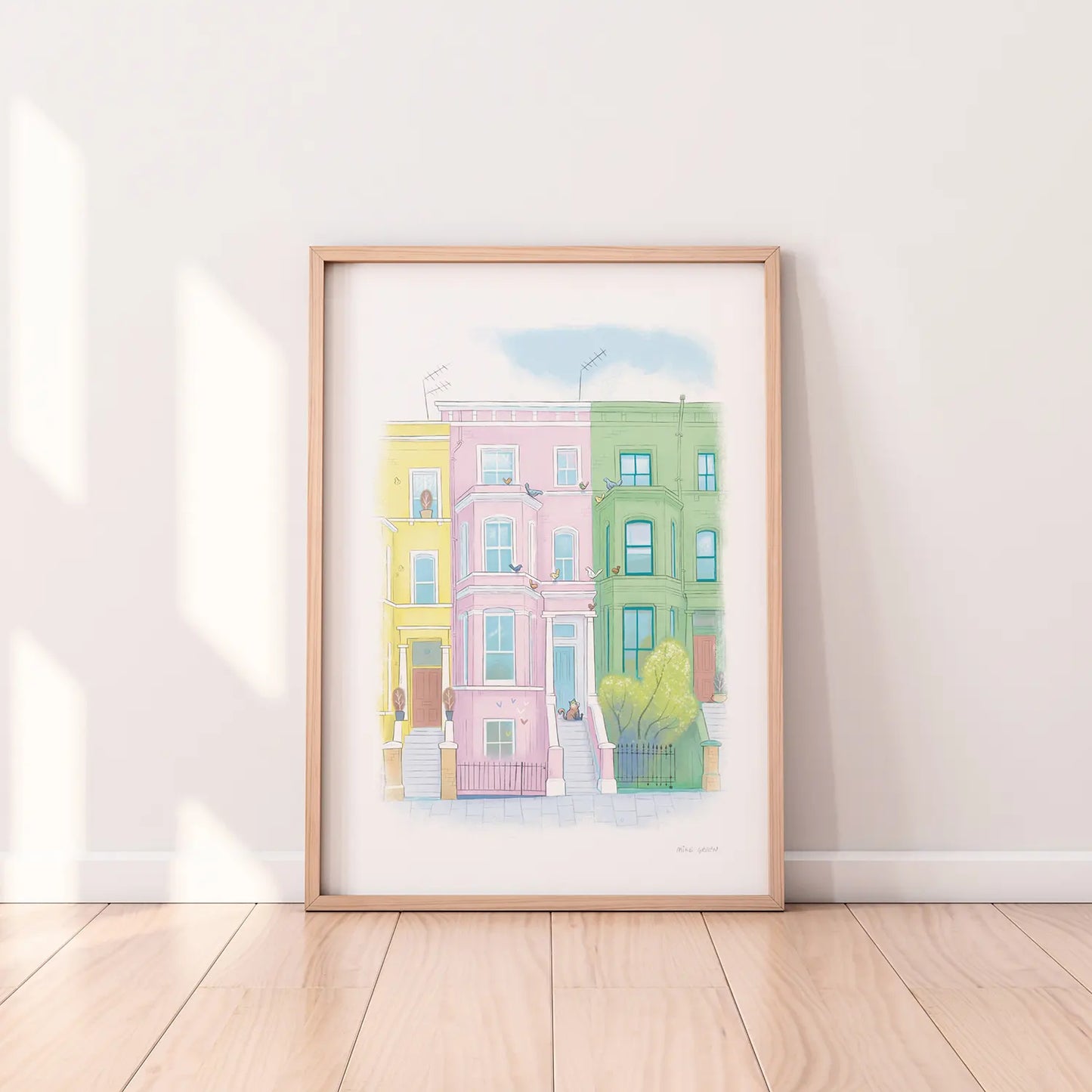 Framed print of an illustration by Mike Green Illustration of a lazy cat in front of colourful Houses on Lancaster road in London's Notting Hill