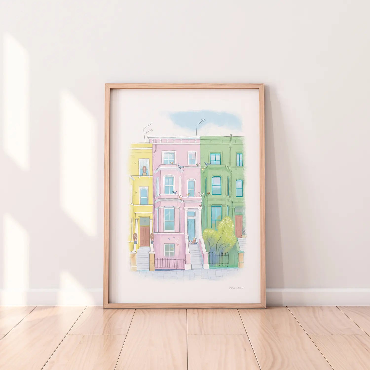 Framed print of an illustration by Mike Green Illustration of a lazy cat in front of colourful Houses on Lancaster road in London's Notting Hill