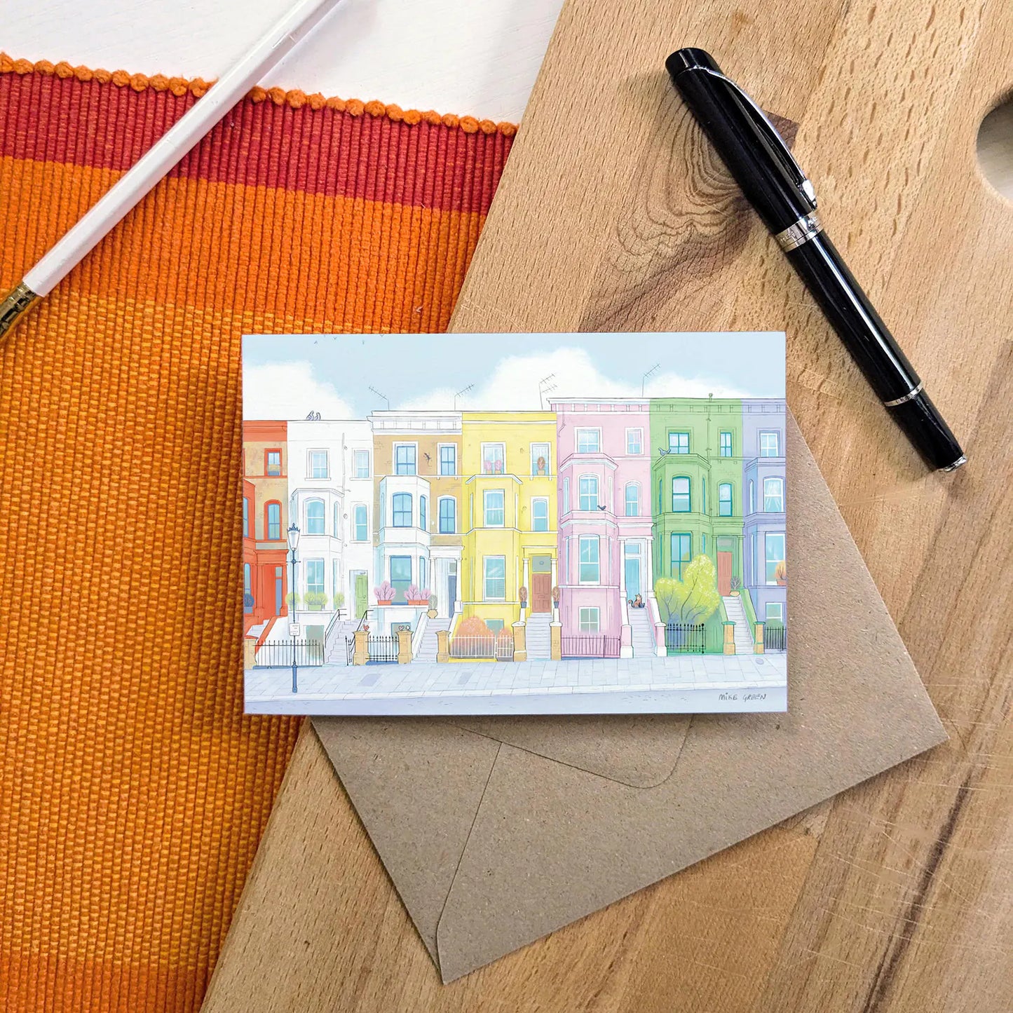 Colourful greetings card with houses from London's Notting Hill with an envelope and pen