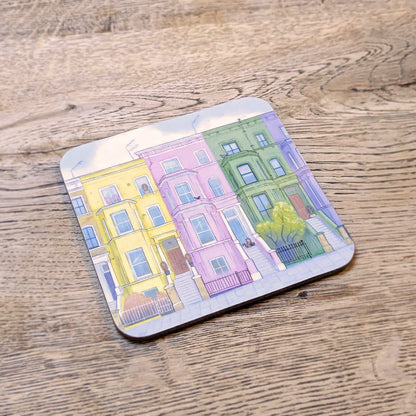 Coaster with colourful houses from London's Notting Hill on a wooden surface