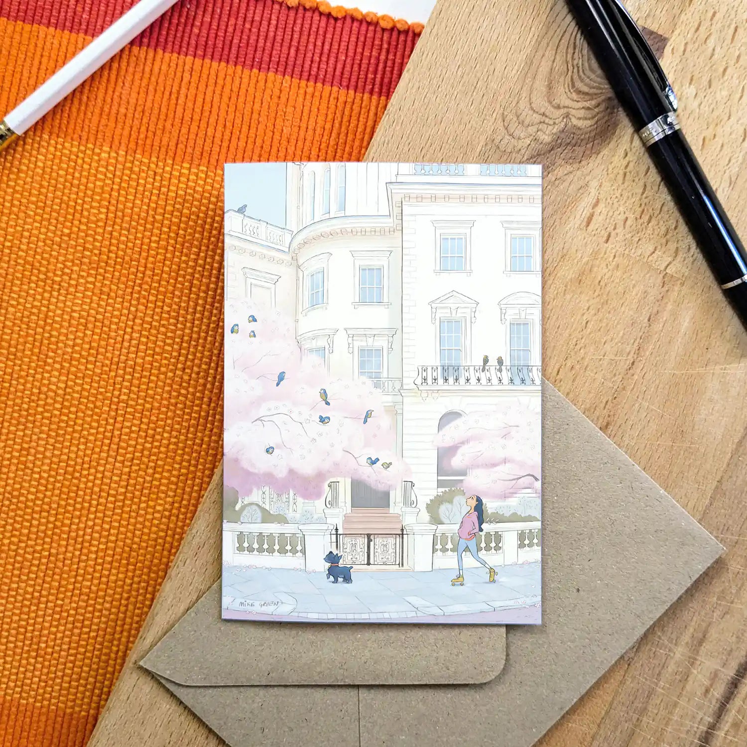 A lady and her dog skates through londons Kensington in the spring in this beautifully illustrated greeting card by mike green illustration.