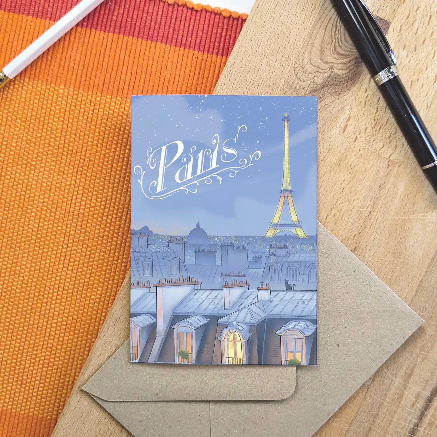 Paris night skyline with 'Paris' title beautifully illustrated on a greeting card by mike green illustration.