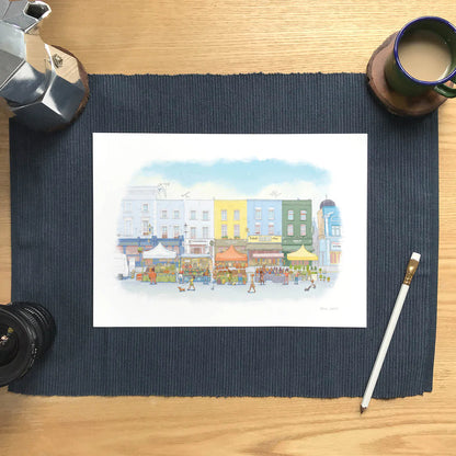 Wall art print of an illustration of Portobello Road market in London's Notting Hill with a pencil and cup of coffee